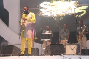 Mike Aremu performing on stage