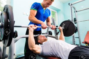 Men in sport gym training with barbell for fitness