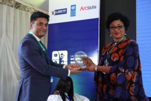 Amit Washington, the CEO of Arc Skills presenting the plaque to Sola Babatunde as one of the panelist after the Apparel Panel discussion. 