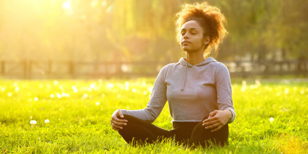 African american woman meditating in nature - Fab Magazine